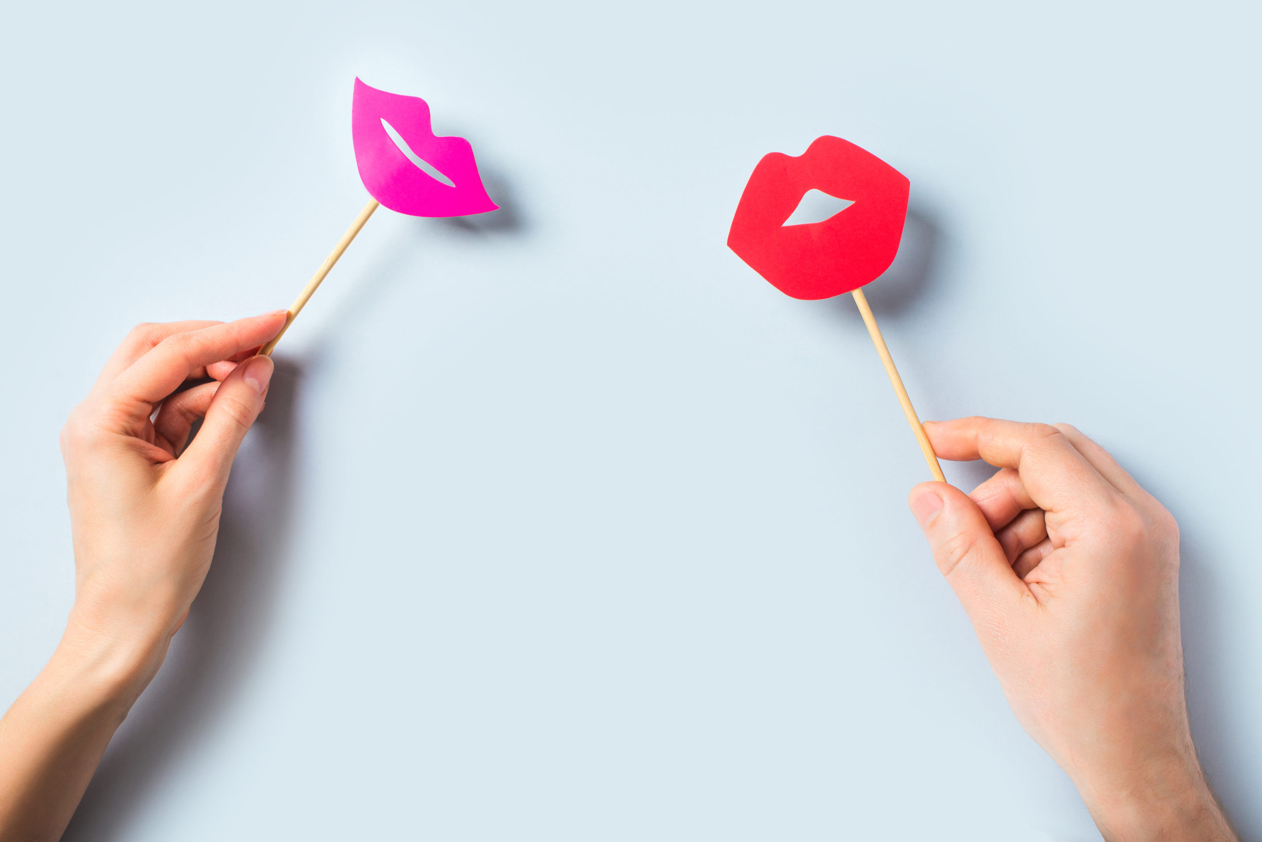 World kissing day concept with lips on stick on blue background