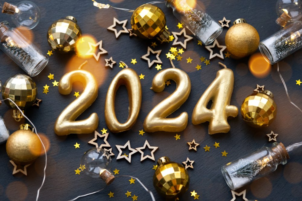 The golden figures 2024 made of candles on a black stone slate b